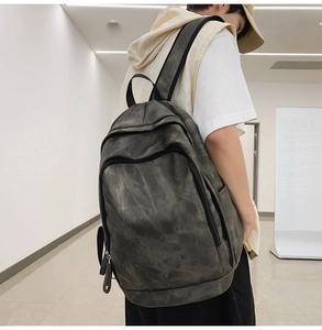 Detail of washed charcoal grey canvas backpack with dual zippers and side water bottle pocket