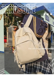 Street view of a cream large-capacity nylon backpack with multiple functional pockets