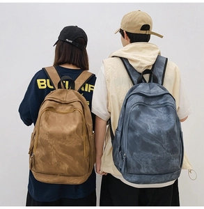 Detail view of large capacity backpacks with washed texture in brown and blue-grey colors