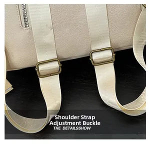 Close-up of adjustable metal buckle on beige leather backpack woven shoulder strap