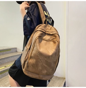 Detailed view of brown retro large capacity backpack with textured fabric on a model
