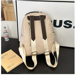 Detail of the anti-theft zipper pocket and canvas straps on the cream vintage backpack