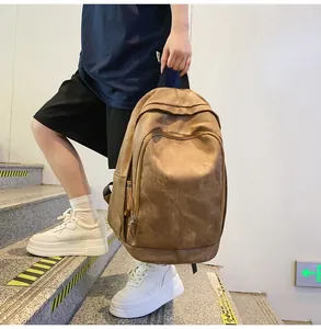 Brown canvas travel backpack detail showing large capacity and side storage pockets