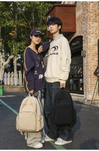 Outdoor shot of models carrying large capacity black and beige minimalist nylon backpacks
