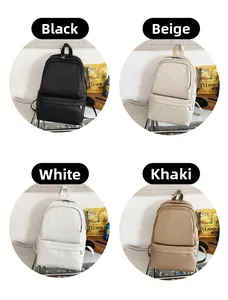 Detail of four school backpacks in black, beige, white, and khaki with front zip pockets