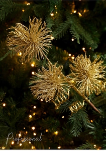 Detailed view of golden glitter flower branch with three sparkling heads on a Christmas tree