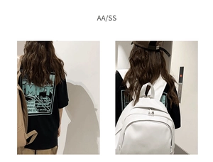 Detail of oversized black street style t-shirt featuring graphic back print and backpack