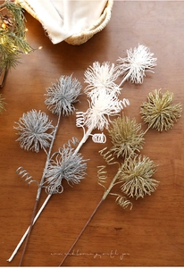 Close-up of sparkling Christmas glitter floral picks in gold, silver, and white tones