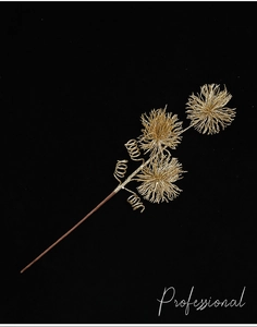 Macro detail of gold glitter artificial branch with floral heads for Christmas decoration