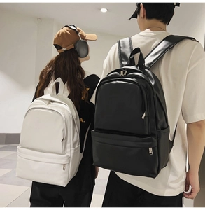 Detailed view of modern minimalist backpacks in black and white with side pockets