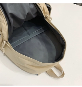Macro detail of spacious backpack interior with tablet compartment and dual zipper design