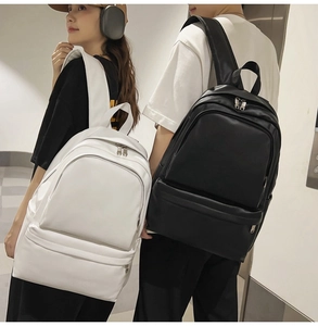 Black and white minimalist backpacks showing size and fit on male and female models