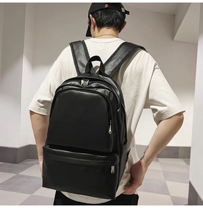 Rear view of model wearing a minimalist black leather backpack with matte PU finish
