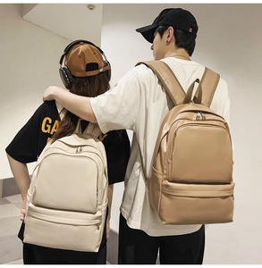 Minimalist PU leather backpacks in beige and khaki shown as a couple bag on models