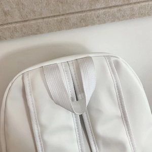 Close-up of durable handle and white webbing on minimalist stylish backpack