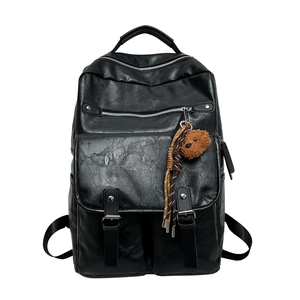 Black vintage leather backpack for students with multiple pockets and a cute bear charm