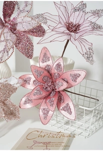 Close-up of pink champagne Christmas flowers with glitter petals in a white vase