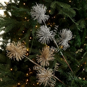 Glittering gold and silver Christmas flower branches with fireworks spray on a festive tree