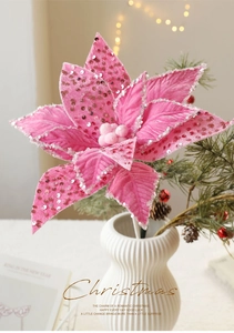 Close-up of pink champagne Christmas flower decoration with sparkling sequins and velvet fabric