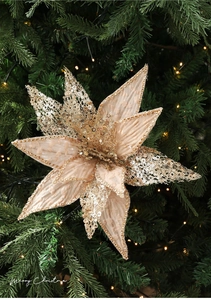 Detail of champagne gold mesh flower with sequins on a lit Christmas tree branch