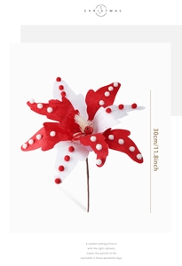 Macro detail of red and white polka dot fabric Christmas flower with festive jingle bell
