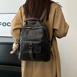 Vintage black faux leather backpack with brown trim and cute cat plush pendant charm