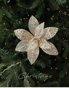 Close-up of golden Christmas mesh flower with sequins on a decorated green tree