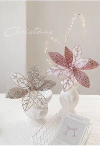Close-up of sparkling mesh Christmas flowers with sequins and beads in ceramic vase