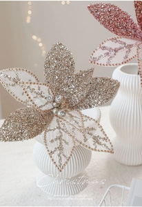Detailed view of champagne and pink mesh Christmas flowers with sequins and faux gems