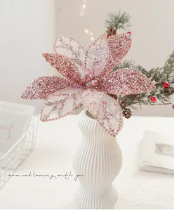 Detail of rose gold glitter artificial Christmas flower with mesh petals and center beads