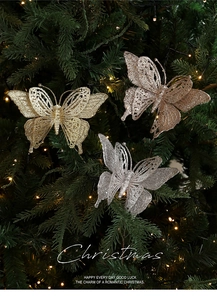 Glitter butterfly Christmas tree picks in gold and silver hanging on a festive tree