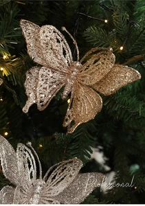 Macro detail of glitter butterfly Christmas picks with hollow gold and silver wings