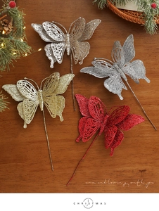 Close-up of glitter hollow butterfly pick for festive Christmas tree and floral decor