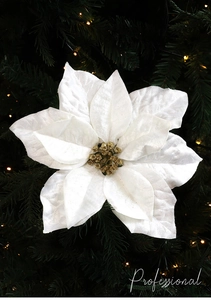 Macro view of white velvet poinsettia with gold glitter stamens on Christmas tree