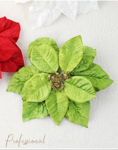 Macro detail of artificial green Christmas poinsettia with gold glitter stamen and velvet leaf