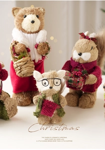 Detailed close-up of sisal animal Christmas figurines with festive red and green knit accessories