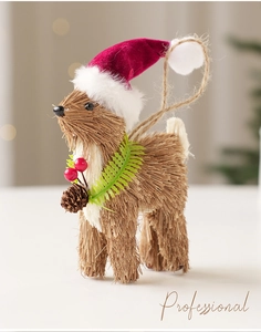 Detail of straw-woven Christmas reindeer ornament with red velvet hat and pine cone