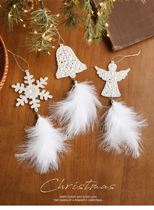 Detailed view of white feather snowflake and angel ornaments for Christmas tree decor