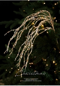 Macro detail of golden sequin Christmas branch decoration with festive glitter finish