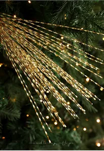 Macro shot of glittery golden spiral branches with sequins for Christmas tree decor