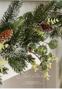 Macro detail of artificial pine branches, pine cones, and eucalyptus with faux snow