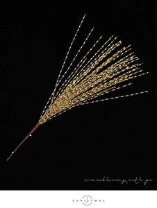 Close-up of golden glitter Christmas branch with spiraled sequin fireworks design