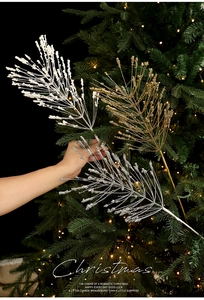Close-up of glittered gold, silver, and white Christmas picks for festive tree decoration