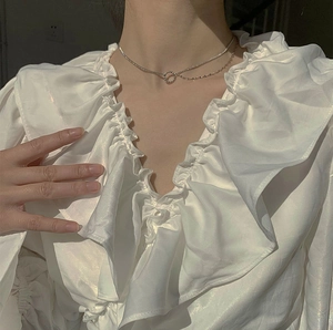 Minimalist S925 silver layered circle necklace worn with a white ruffle V-neck satin shirt