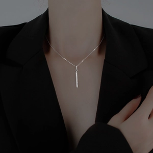 Close-up of elegant silver vertical bar pendant necklace with sparkling micro-pave crystals