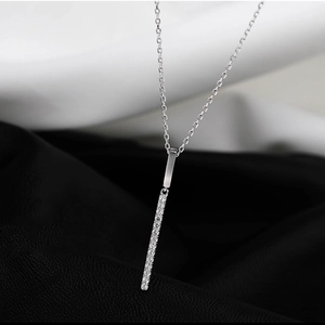 Macro shot of silver bar pendant necklace with sparkling micro-inlaid zircons and chain