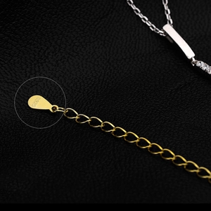 S925 sterling silver bar necklace with diamond pendant on black leather background