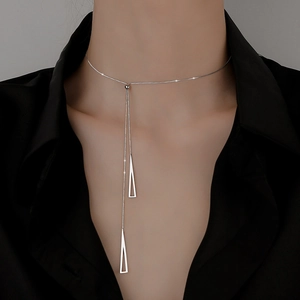 Detailed view of silver geometric Y-shaped necklace with dual triangle tassel pendants