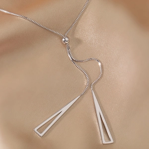 Adjustable silver Y-necklace with geometric triangle pendants on champagne satin background
