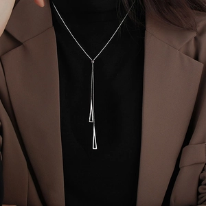Minimalist Y-shaped necklace with geometric hollow triangle pendants on a professional model